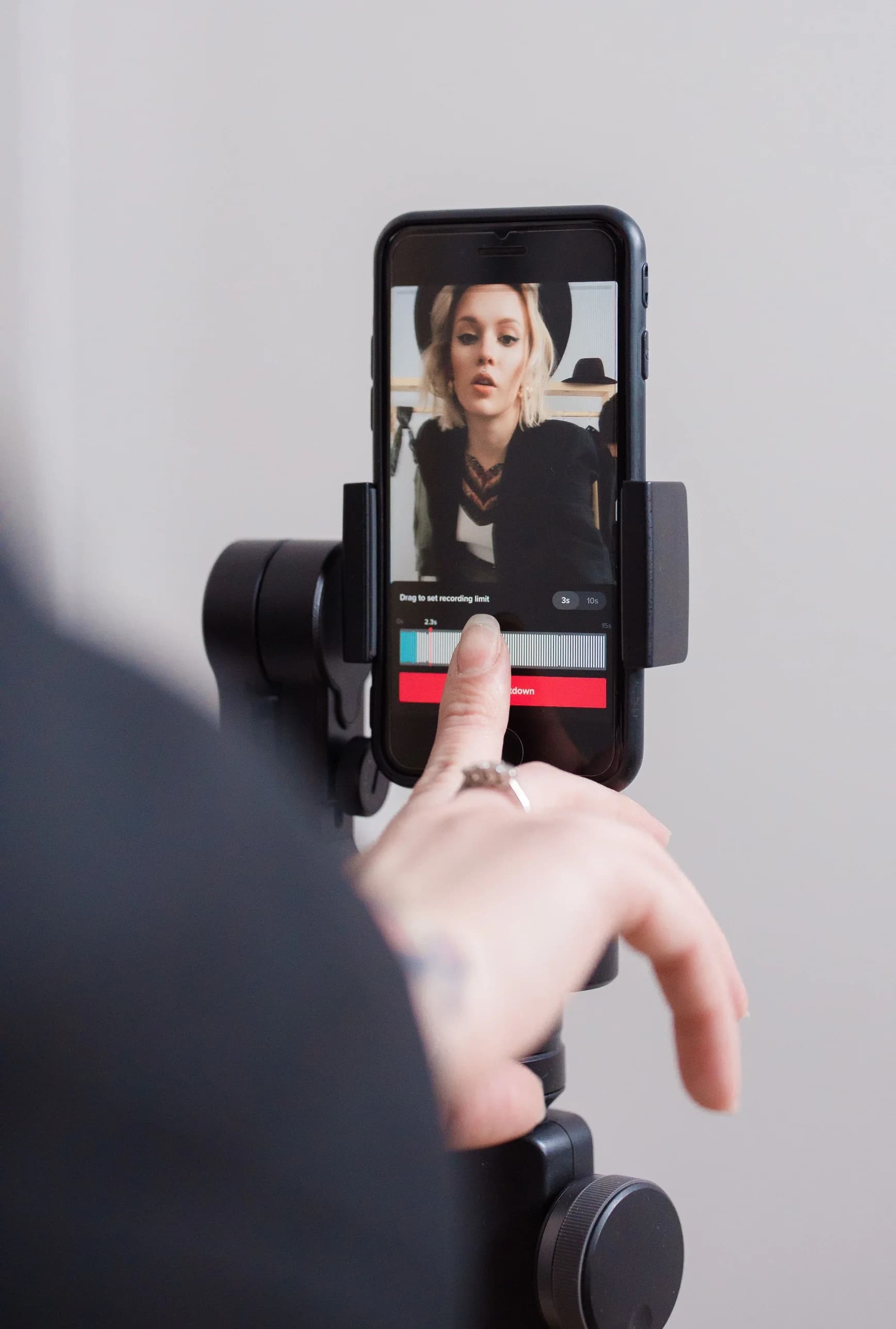 Student recording social media content on a phone