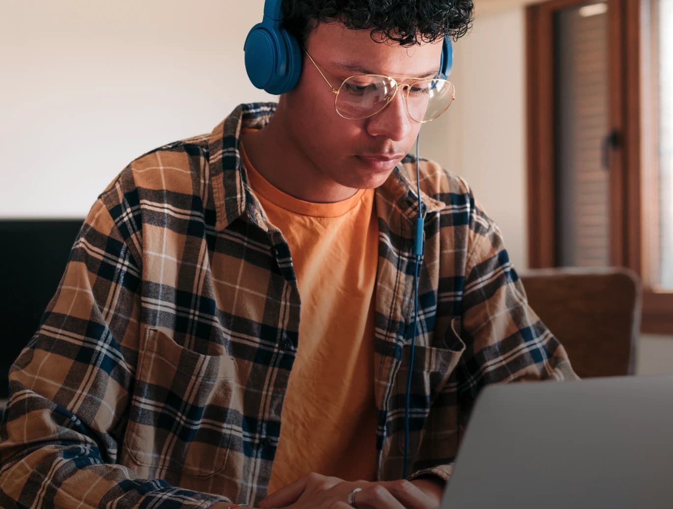 Student studying on a laptop with headphones