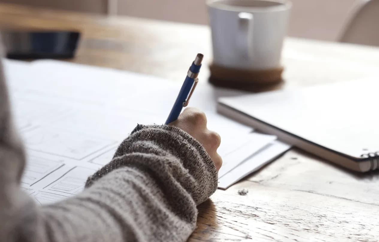 student taking exam with pencil