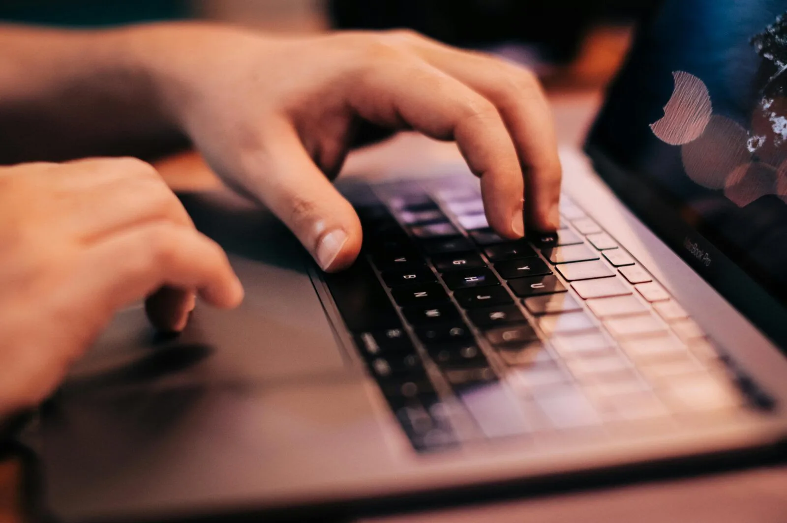 Hands typing on a keyboard