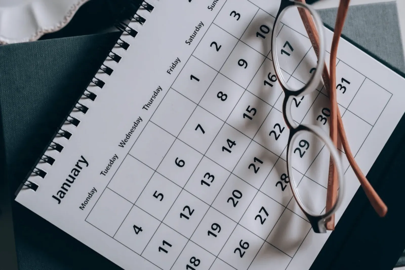 calendar with glasses placed on top