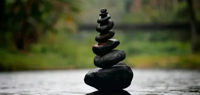 Balanced stones in water, calm natural setting